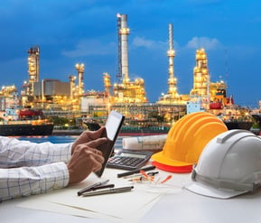 engineering-working-on-computer-tablet-against-beautiful-oil-refinery-small.jpg