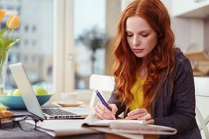 woman taking notes on laptop computer.jpg
