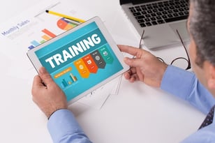 Man working on tablet, training is written on screen